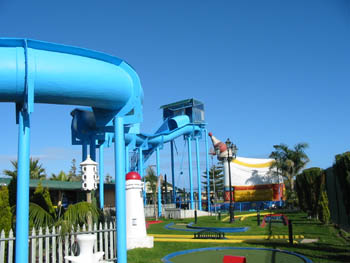 Mini Golf area with Waterslide above and Bouncing Castle in the background